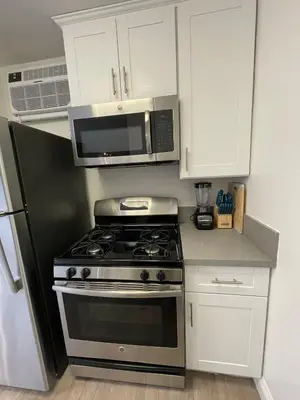 a kitchen with a stove and a microwave at Hollywood Spectacular Loft FREE Designated parking in Los Angeles