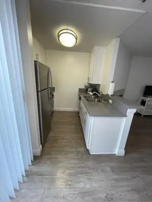 a kitchen with a sink and a refrigerator at Hollywood Spectacular Loft FREE Designated parking in Los Angeles