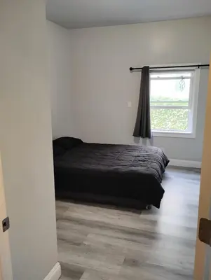 a bedroom with a bed and a window at Hollywood Homes of Love in Los Angeles