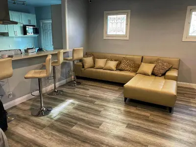a living room with a couch and a kitchen at Hollywood Homes of Love in Los Angeles
