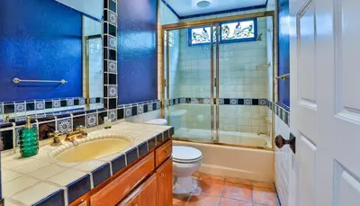 a bathroom with a toilet and a tub and a sink at Estate with Heated Pool & Jacuzzi & Tennis Court in Sherman Oaks Community Hospital Heliport