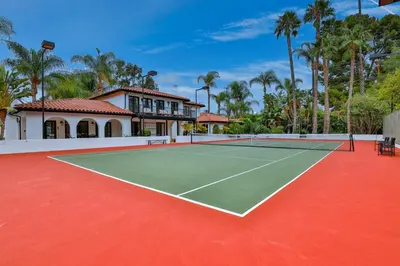 a tennis court in front of a house at Estate with Heated Pool & Jacuzzi & Tennis Court in Sherman Oaks Community Hospital Heliport