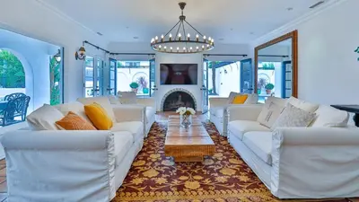 a living room with white couches and a fireplace at Estate with Heated Pool & Jacuzzi & Tennis Court in Sherman Oaks Community Hospital Heliport