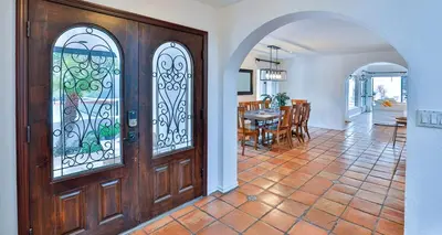 a room with a wooden door and a dining room at Estate with Heated Pool & Jacuzzi & Tennis Court in Sherman Oaks Community Hospital Heliport