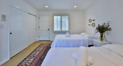 a bedroom with two beds and a rug at Estate with Heated Pool & Jacuzzi & Tennis Court in Sherman Oaks Community Hospital Heliport