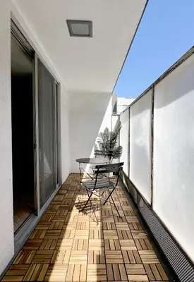 a balcony with a table and chairs on it at Seabreeze Hideaway one bedroom in Los Angeles