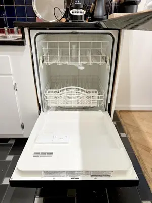 an open dishwasher with its door open in a kitchen at Seabreeze Hideaway one bedroom in Los Angeles