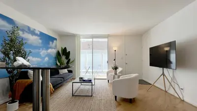a living room with a couch and a tv at Seabreeze Hideaway one bedroom in Los Angeles