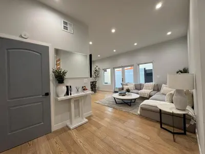 a living room with a couch and a table at Newly constructed 2 bedroom by La Cienega Plaza with parking, modern kitchen, washer dryer and very central to attractions in Los Angeles