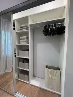 a white closet with a glass door and shelves at Newly constructed 2 bedroom by La Cienega Plaza with parking, modern kitchen, washer dryer and very central to attractions in Los Angeles