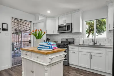 a kitchen with white cabinets and a counter top at Walgrove Guest House in Los Angeles