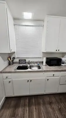 a kitchen with white cabinets and a sink at Spacious Silverlake Apartment in Los Angeles