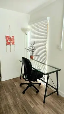 a glass desk and a chair in a room at Spacious Silverlake Apartment in Los Angeles
