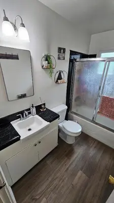 a bathroom with a toilet and a sink and a shower at Spacious Silverlake Apartment in Los Angeles