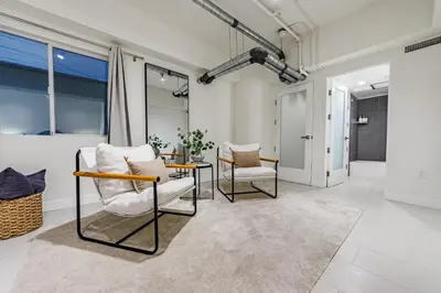 a living room with two chairs and a table at Modern Loft 1BR in Downtown LA! in Los Angeles