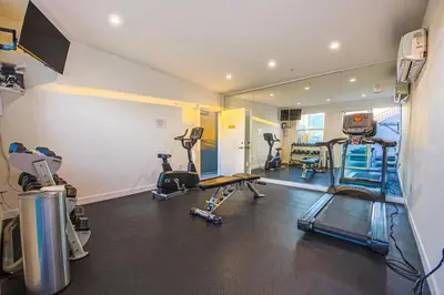 a gym with several treadmills and machines in a room at Modern Loft 1BR in Downtown LA! in Los Angeles