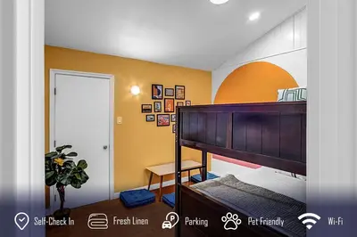 a bedroom with a bunk bed and a yellow wall at 6BR 3BA Home near Disneyland in Anaheim