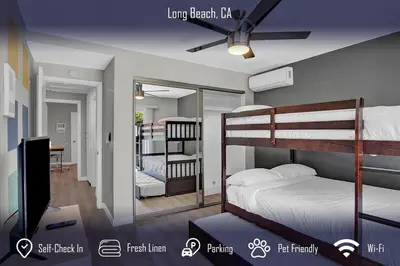 a room with two bunk beds and a television at Chic 4B2B Townhome Private Pool in Long Beach