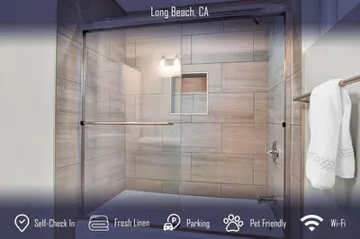 a shower with a glass door in a bathroom at Chic 4B2B Townhome Private Pool in Long Beach