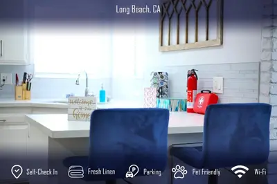 two blue chairs sitting in front of a kitchen counter at Chic 4B2B Townhome Private Pool in Long Beach