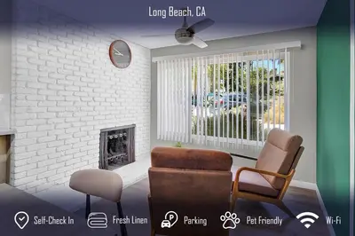 a living room with two chairs and a fireplace at Chic 4B2B Townhome Private Pool in Long Beach