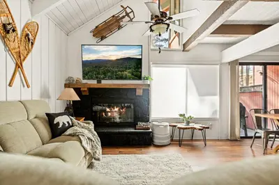 a living room with a couch and a fireplace at Summit Slope Side in Big Bear Lake