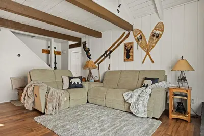 a living room with a couch and a rug at Summit Slope Side in Big Bear Lake