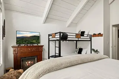a bedroom with a bed and a fireplace at Summit Slope Side in Big Bear Lake