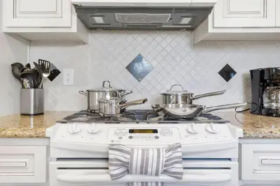 a kitchen with two pots on top of a stove at Blue Haven Solar Pool Heat Parking Billiards in Long Beach