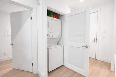 a white laundry room with a washer and dryer at Pacific Pearl 2 bed Apt with FREE PARKING in Santa Monica in Los Angeles