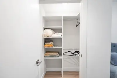 a closet with white shelves at Pacific Pearl 2 bed Apt with FREE PARKING in Santa Monica in Los Angeles