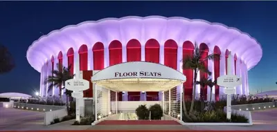 a building with red and white columns at night at Luxury Master Bedroom with private bathroom walking distance to Sofi Stadium, KIA Forum and Intuit Dome also only train stop away from LAX airport Perfect place for tourists and event attendees in Inglewood