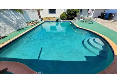 a large swimming pool with blue water at Luxury Master Bedroom with private bathroom walking distance to Sofi Stadium, KIA Forum and Intuit Dome also only train stop away from LAX airport Perfect place for tourists and event attendees in Inglewood