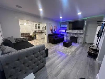 a living room with a couch and a fireplace at Luxury Master Bedroom with private bathroom walking distance to Sofi Stadium, KIA Forum and Intuit Dome also only train stop away from LAX airport Perfect place for tourists and event attendees in Inglewood