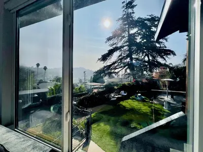 a window of a house with a view of a yard at The Perch- Hilltop Bungalow, Eagle Rock-near DTLA in Los Angeles