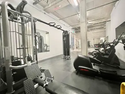a gym with treadmills and exercise bikes in it at Penthouse 2 Bedroom with Hollywood Sign View! in Los Angeles