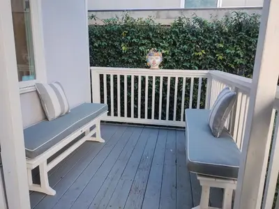 a porch with two chairs and a bush at Venice Canals & Beach Guest Suite in Los Angeles