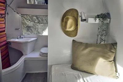 a bathroom with a tub and a sink and a pillow at Secluded Pet Friendly Airstream in Calabasas, California in Calabasas