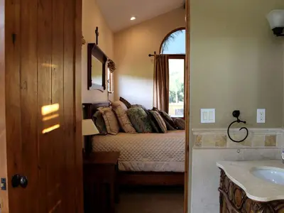 a bathroom with a bed and a sink in a room at Romantic and Relaxing Villa Retreat with a Jacuzzi near Somis, California in Somis
