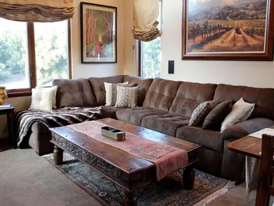 a living room with a brown couch and a coffee table at Romantic and Relaxing Villa Retreat with a Jacuzzi near Somis, California in Somis