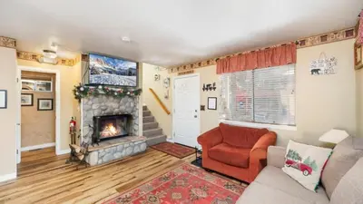 a living room with a couch and a fireplace at Charming Cabin for Winter and Water Sports Fans Near Big Bear Lake, California in Arrowbear Lake