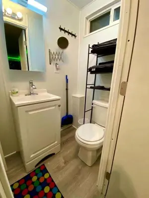 a bathroom with a toilet and a sink and a mirror at Fully Refurbished Container in Devore Heights, California, for Glamping Trips on Route 66 in Devore Heights