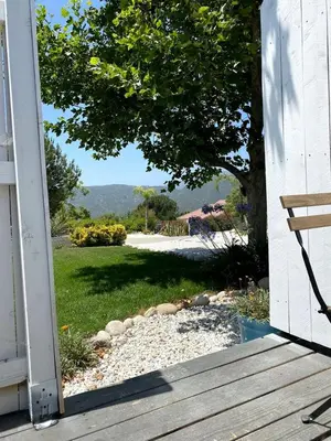 an open door of a house with a view of a yard at Fully Refurbished Container in Devore Heights, California, for Glamping Trips on Route 66 in Devore Heights