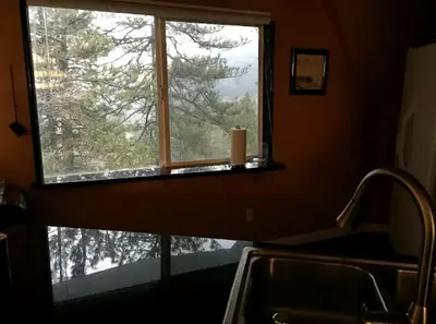 a window in a kitchen with a candle on the counter at Unique Three-Level Dome near Lake Gregory in Crestline, California in Crestline