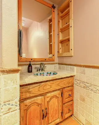 a bathroom with a sink and a mirror at Stunning Cabin with Indoor Jacuzzi Ideal for a Weekend Getaway from Los Angeles in Pine Mountain Club