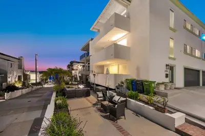 an apartment building with a patio with chairs and plants at Manhattan Beach Guest Suite in Manhattan Beach