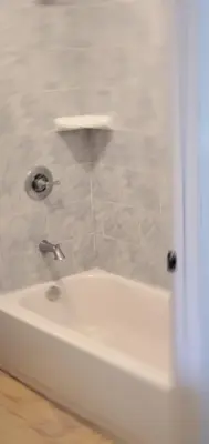 a bathroom with a white tub and a sink at El Rio Motel in Glendale
