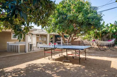 a ping pong table and a hammock in a yard at Avengers HQ - Hot Tub - Close to Disney - Parking in Anaheim