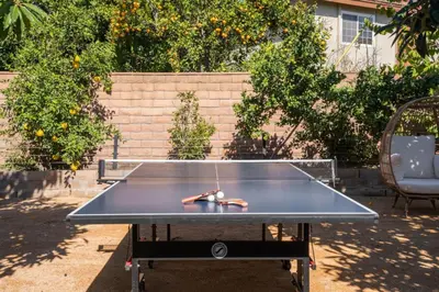 a ping pong table with a racket on top of it at Avengers HQ - Hot Tub - Close to Disney - Parking in Anaheim