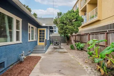 a house with a blue building and a sidewalk at Sunset Shores - Near the beach - Games - Sleeps 8 in Long Beach